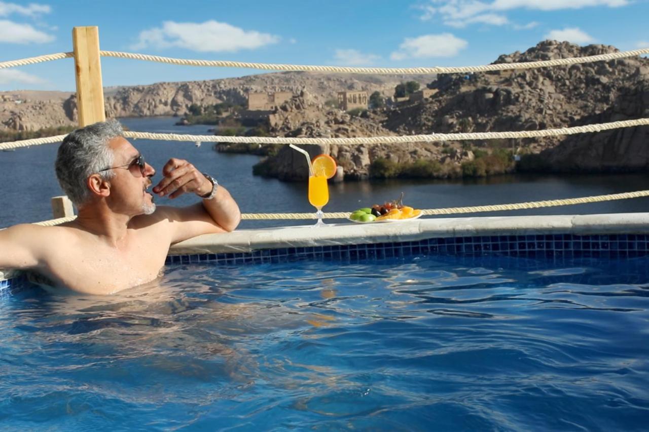 Benben By Dhara Hotels - Adults Only Aswan Exteriör bild A man relaxing in a swimming pool